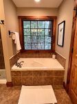 The ensuite bath has a large soaking tub.